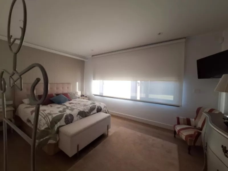 Imagen mostrando la integración de la Casa en Oleiros con el paisaje del paseo del río.